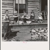 Millworker's children eating watermelon on porch of rented house. Six miles north of Roxboro, Person County, North Carolina