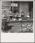 Millworker's children eating watermelon on porch of rented house. Six miles north of Roxboro, Person County, North Carolina