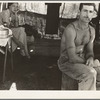 Unemployed lumber worker goes with his wife to the bean harvest. Note social security number tattooed on his arm. Oregon. See general caption number 46