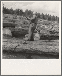 "Pond monkey" steers log raft in mill pond. Keno, Klamath County, Oregon. General caption number 61