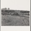 Young family on ditch bank, waiting to enter farm family labor camp (FSA - Farm Security Administration). They came from North Dakota, have young baby. "Two years in this kind of work." Merrill, Klamath County, Oregon