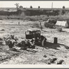 Camped on the flat. Family with five children, left their home in Texas in September 1938. They picked their way across the country in Texas and Arizona cotton. They had just entered California the night before. Near Holtville, Imperial County, California