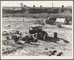 Camped on the flat. Family with five children, left their home in Texas in September 1938. They picked their way across the country in Texas and Arizona cotton. They had just entered California the night before. Near Holtville, Imperial County, California