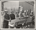 Seven of the eight farmers shown with their cooperatively owned ensilage cutter on the Miller farm, where they are working filling the silo. West Carlton, Yamhill County, Oregon. General caption number 58