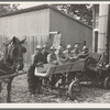 Seven of the eight farmers shown with their cooperatively owned ensilage cutter on the Miller farm, where they are working filling the silo. [West Carlton], Yamhill County, Oregon. General caption number 58