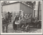 Seven of the eight farmers shown with their cooperatively owned ensilage cutter on the Miller farm, where they are working filling the silo. [West Carlton], Yamhill County, Oregon. General caption number 58