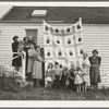 Farm women of the "Helping Hand" club display a pieced quilt which they are making for the benefit of one of their numbers. Near West Carlton, Yamhill County, Oregon. General caption number 58-11