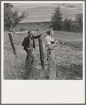 Farmer and boy in the fall of the year at the time the hunting season opens. They live in a white painted house across the road. Jackson County, Oregon