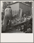 Farmers feeding corn into cooperatively owned ensilage cutter. Near W Street at Carlton, Yamhill County, Oregon. General caption number 58