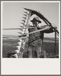 Mr. Browning in his field getting ready to mow hay. Dead Ox Flat, Malheur County, Oregon. General caption number 67-111