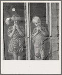 Two of the seven Browning children in doorway of their Oregon home. Dead Ox Flat, Malheur County, Oregon. General caption number 67-111