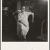 Mrs. Hull, in one room basement dugout home, late afternoon. Dead Ox Flat, Malheur County, Oregon. General caption number 67-111