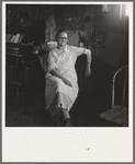 Mrs. Hull, in one room basement dugout home, late afternoon. Dead Ox Flat, Malheur County, Oregon. General caption number 67-111