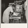 Mrs. Hull drying corn. She hopes to sell enough to help her son through Bible school. Dead Ox Flat, Malheur County, Oregon