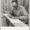 Oklahoma farmer, now living in Cow Hollow, is a FSA (Farm Security Administration) borrower. Seen here signing his chattel mortgage. Malheur County, Oregon