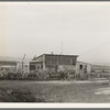 The home of a new farmer who has successfully established himself on the raw land. He has repaid his FSA (Farm Security Administration) loan of twelve hundred and forty-eight dollars in full. Family arrived on the project in August 1937