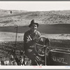 Young farmer, member of Ola self-help sawmill co-op, plowing in fall of the year. Tractor is used co-operatively. Gem County, Idaho. General caption 48