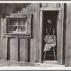 Wife and baby of president of Ola self-help sawmill co-op in doorway of their home. Gem County, Idaho. General caption 48