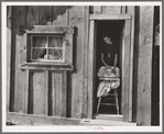 Wife and baby of president of Ola self-help sawmill co-op in doorway of their home. Gem County, Idaho. General caption 48