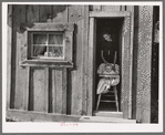 Wife and baby of president of Ola self-help sawmill co-op in doorway of their home. Gem County, Idaho. General caption 48