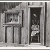 Wife and baby of president of Ola self-help sawmill co-op in doorway of their home. Gem County, Idaho. General caption 48