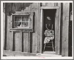 Wife and baby of president of Ola self-help sawmill co-op in doorway of their home. Gem County, Idaho. General caption 48