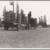 Farmer and his boy hauling water for drinking and domestic purposes to the stump farm. Boundary County, Idaho. General caption 53