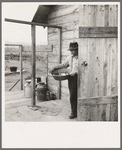 New settler shows fish he caught this morning. He "likes it fine here." Priest River Valley, Bonner County, Idaho. See general caption 54