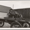 Stump farmer's wagon. Note cream can tied behind store on Saturday afternoon, approaching winter. Bonners Ferry, Idaho. See general caption 49