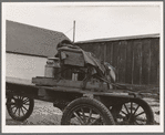 Stump farmer's wagon. Note cream can tied behind store on Saturday afternoon, approaching winter. Bonners Ferry, Idaho. See general caption 49