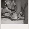 The doctor examines the boy from Texas. In mobile unit of FSA (Farm Security Administration) camp, Merrill, Klamath County, Oregon. See general caption 62