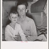 He brought his family to the west in a homemade trailer from Texas five months ago. Photograph made after supper. Boy sick. Father has work now in potato field. Merrill, Klamath County, Oregon. In mobile unit, FSA (Farm Security Administration) camp
