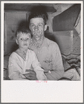 He brought his family to the west in a homemade trailer from Texas five months ago. Photograph made after supper. Boy sick. Father has work now in potato field. Merrill, Klamath County, Oregon. In mobile unit, FSA (Farm Security Administration) camp