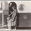 Young mother brings her child to the trailer clinic on the day when the doctor will be in camp to examine some of the children. Klamath County, Oregon. FSA (Farm Security Administration) camp