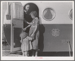 Young mother brings her child to the trailer clinic on the day when the doctor will be in camp to examine some of the children. Klamath County, Oregon. FSA (Farm Security Administration) camp