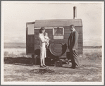 The doctor reassures the mother after having seen the sick baby in the trailer. Merrill, Klamath County, Oregon, at FSA (Farm Security Administration) mobile camp