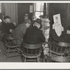 Weighing-in room of the stockyards. Aledo, Illinois. Farmers sitting around the stove enjoying themselves and getting warm. The stove is still a middle western institution