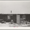 Three-room shack, the residence of L.H. Nissen, hired man for a tenant farmer. Farm is owned by a loan company. Ten people live in the shack: mother, father, seven children, and one grandchild. Iowa