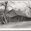 Tool and machine shed on W.H. Cox farm, Clearcreek Township, Johnson County, Iowa. Note how the buildings are propped up. This is an owner-operated farm of one hundred twenty-four acres, sixty of which are tillable