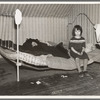 One of Edgar Allen's children sitting on the bed in the house on his farm. There are no sheets, pillowcases, or pillows (other than makeshift) in use. Bedding usually consists of castoff rags and a few old blankets. Near Milford, Iowa