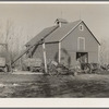 Corn crib on owner-operated farm of G.H. West near Estherville, Iowa. Note wealth of equipment