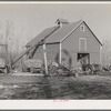 Corn crib on owner-operated farm of G.H. West near Estherville, Iowa. Note wealth of equipment