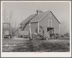 Corn crib on owner-operated farm of G.H. West near Estherville, Iowa. Note wealth of equipment