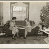Children of H.H. Tripp wrapping presents for Christmas. Near Dickens, Iowa. Tripp operates his mother's farm