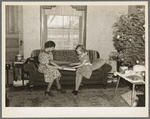 Children of H.H. Tripp wrapping presents for Christmas. Near Dickens, Iowa. Tripp operates his mother's farm