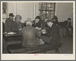 A card game in the recreation room of the homeless men's bureau. Sioux City, Iowa (for unattached men)