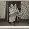 Mrs. Alfred Atkinson with baby and young child in farm home near Shannon City, Iowa. They rent eighty acres from an estate