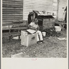 Negro getting a haircut in front of church which houses flood refugees. Sikeston, Missouri