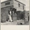 Houses under construction at the Greenhills project. Using the level to lay cinder blocks. Ohio