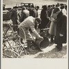Prospective buyer inspecting a feed grinder at Frank Sheroan's closing-out sale near Montmorenci, Indiana